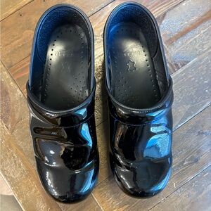 Dansko professional patent leather clogs. Worn but still have some life!